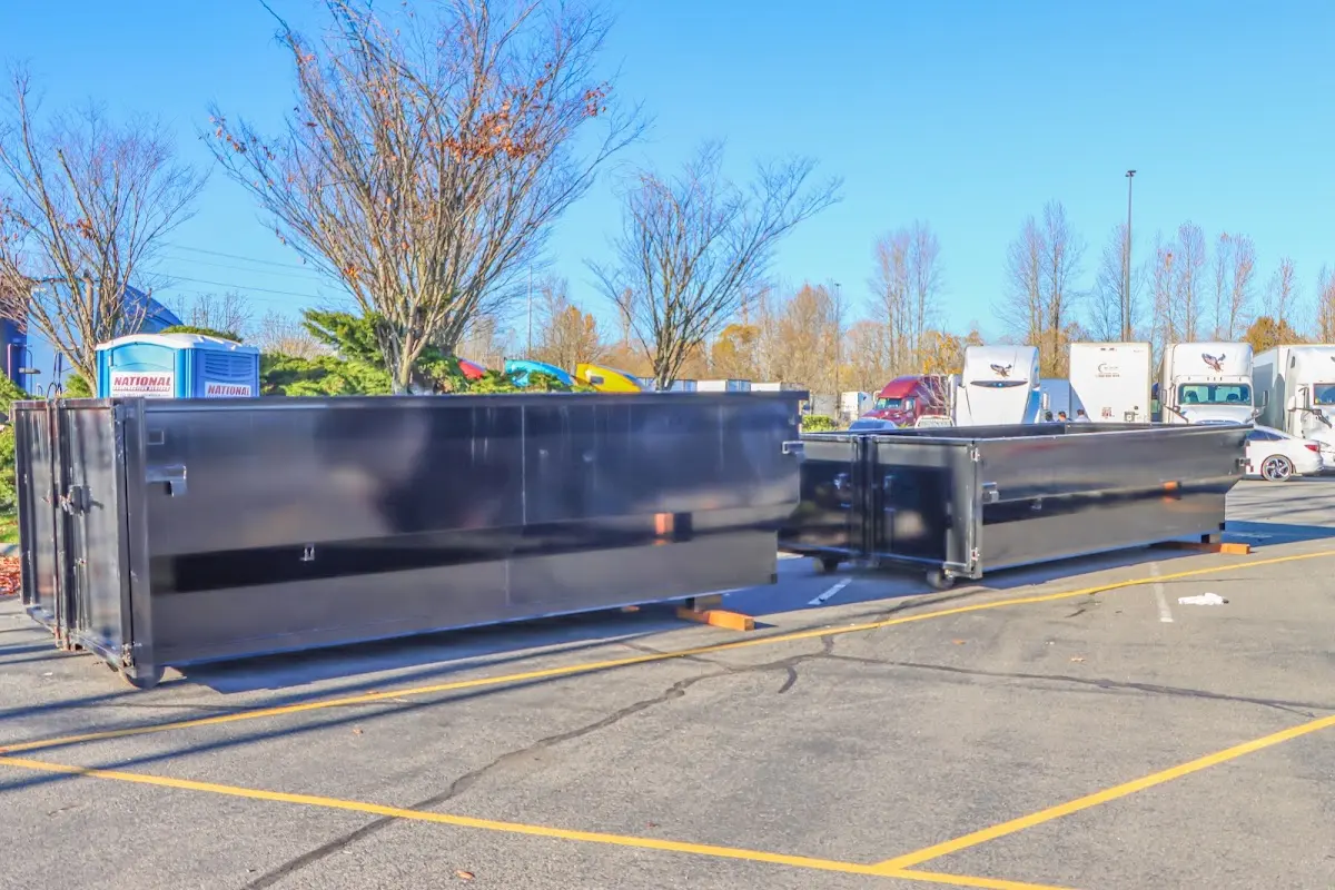 Professional dumpster rental service with roll-off container on residential driveway in Pensacola Station